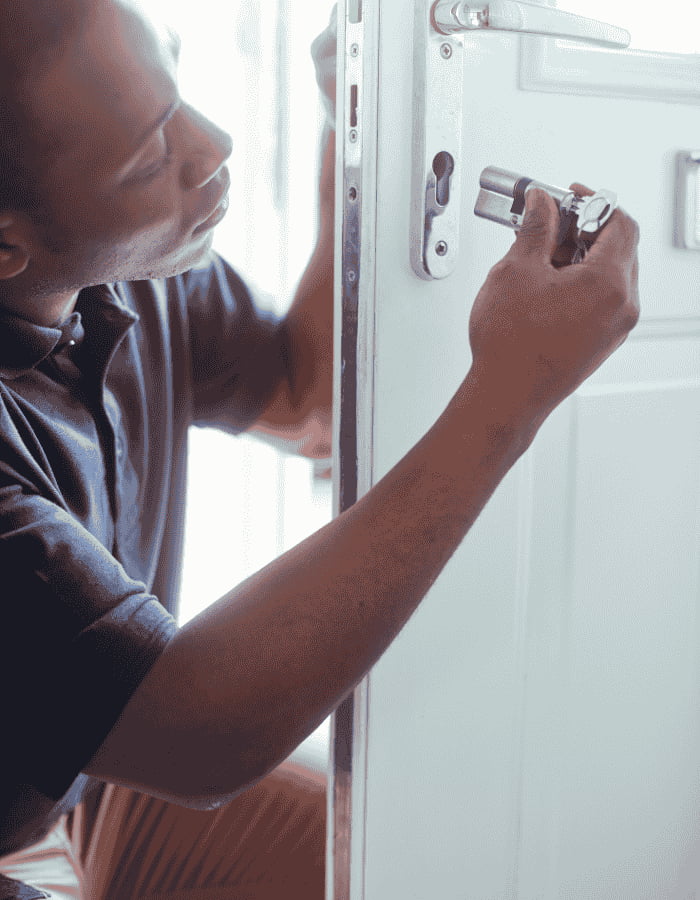 Person installing a door lock.